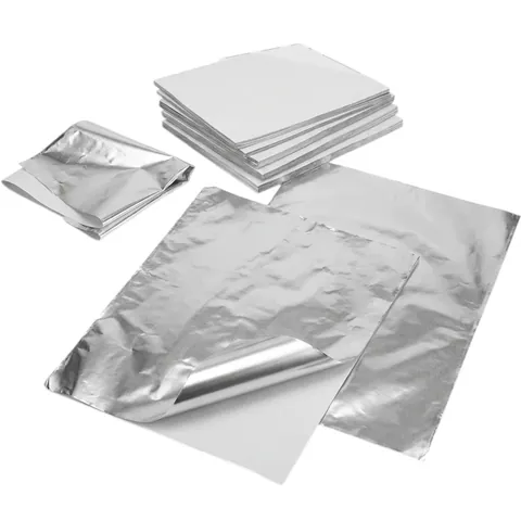 Foil-lined paper wrap sheets: a flat stack, loose sheets with one corner peeled back to show the white paper side, and a folded sheet, foil container, aluminium container