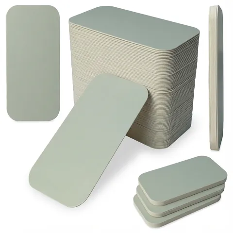 Long rectangular silver-grey board lids with rounded corners, shown loose, on edge and in a tall stack, foil container, aluminium container
