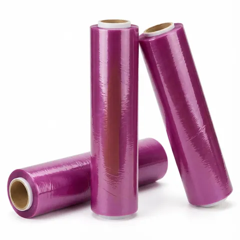 Three rolls of catering cling film on cardboard cores, the film showing a purple tint on the roll, food wrap, clingfilm