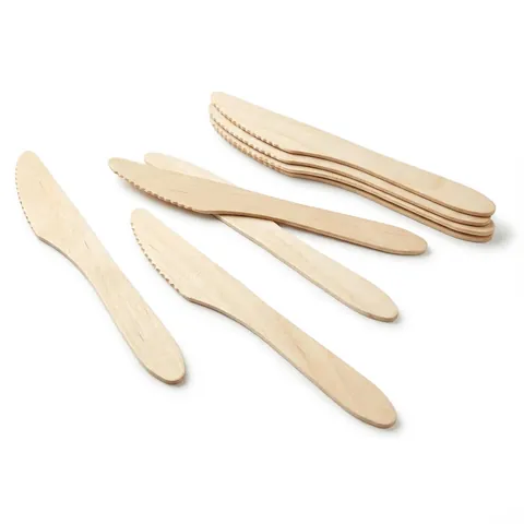 Natural birchwood knives with serrated edges and rounded tips, some loose and some in a small stack, on a white background, wooden cutlery, birchwood cutlery