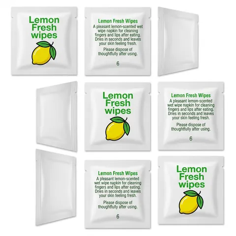 Individually wrapped Lemon Fresh wet wipe sachets, white with green text and a lemon, shown front and back, lemon wipe, moist towelette