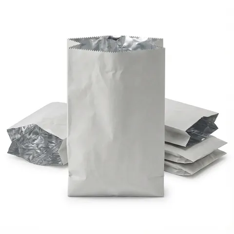 White foil lined paper bags with serrated tops, one standing, others lying flat to show the silver foil lining inside, chicken bag, hot food bag