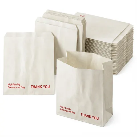 White greaseproof paper bags printed in red with 'High Quality Greaseproof Bag' and 'Thank You', one standing open in front of flat stacks, sandwich bag, baguette bag