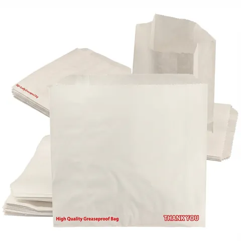 White greaseproof paper bags printed in red with 'High Quality Greaseproof Bag' and 'Thank You', one bag standing open behind flat stacks, sandwich bag, baguette bag