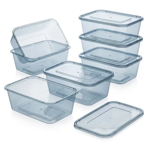Clear rectangular plastic microwave containers stacked with lids on, an open container and a loose lid in front, plastic takeaway container, black base container