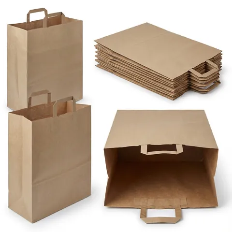 Large brown kraft paper bags with flat paper handles fixed inside, two standing, one open on its side and a stack of flat bags, kraft bag, brown paper bag