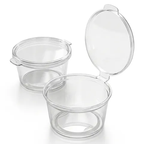 Two clear round 2oz hinged sauce pots, one closed and one with its attached lid open, dip pot, condiment pot