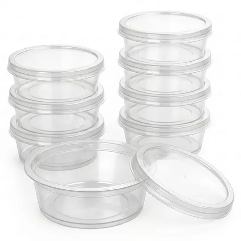 Clear round 2oz sauce pots with separate flat lids, stacked in two columns, with one open pot and its lid in front, dip pot, condiment pot