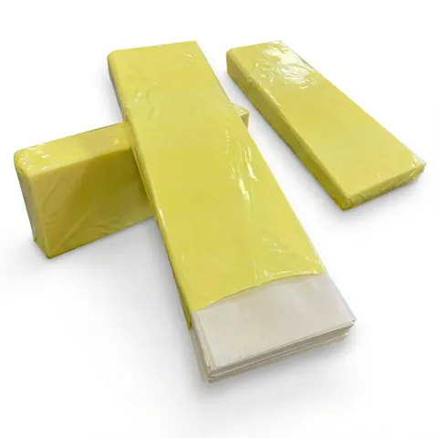 Three long film-wrapped packs of white greaseproof paper sheets, one opened at the end to show the stacked sheets, wrapping paper, butcher paper